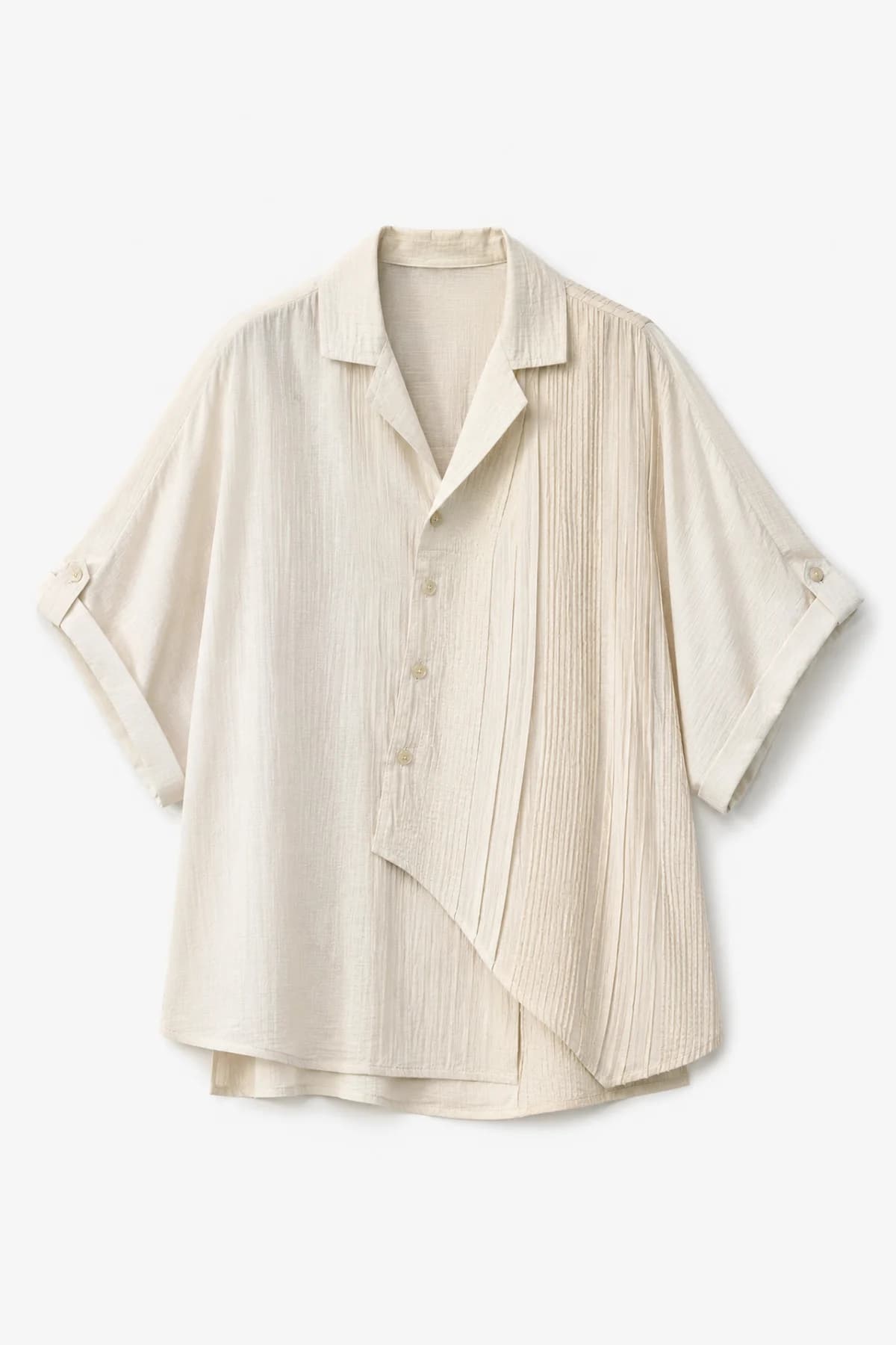 Oatmeal camp-collar shirt laid flat, fine pleating running down one side of the body
